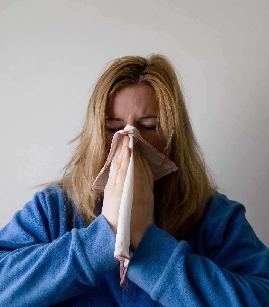 Women Blowing Nose In Tissue